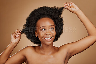 Buy stock photo Happy, black woman and hair care for afro, beauty and wellness in studio isolated on brown background. Growth, curly hairstyle or African model with natural cosmetics after salon treatment for health