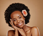 Self care, floral and portrait of woman in studio with beauty, natural and face routine. Skincare, beauty and African female model with flower rose in hair for facial treatment by a brown background.