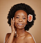 Black woman, face and skincare with rose in studio isolated on a brown background. Portrait, flower and happy African model with natural cosmetics, organic facial treatment and floral beauty plant.