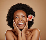 Face, black woman and skincare with rose for beauty in studio isolated on a brown background. Floral flower, excited and African model with natural cosmetics, thinking and organic facial treatment.