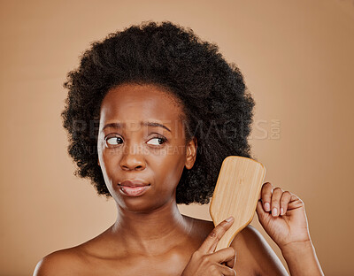 Buy stock photo Sad black woman, hair and unhappy with brush in studio, brown background and afro. Beauty, worried african female model and comb hairstyle with anxiety, knot and problem of damage to natural texture