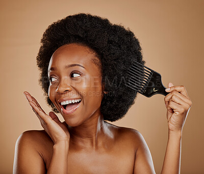 Buy stock photo Hair, comb and a happy model black woman in studio on a brown background for beauty or cosmetics. Aesthetic, afro and haircare with an attractive young female person looking excited for natural care