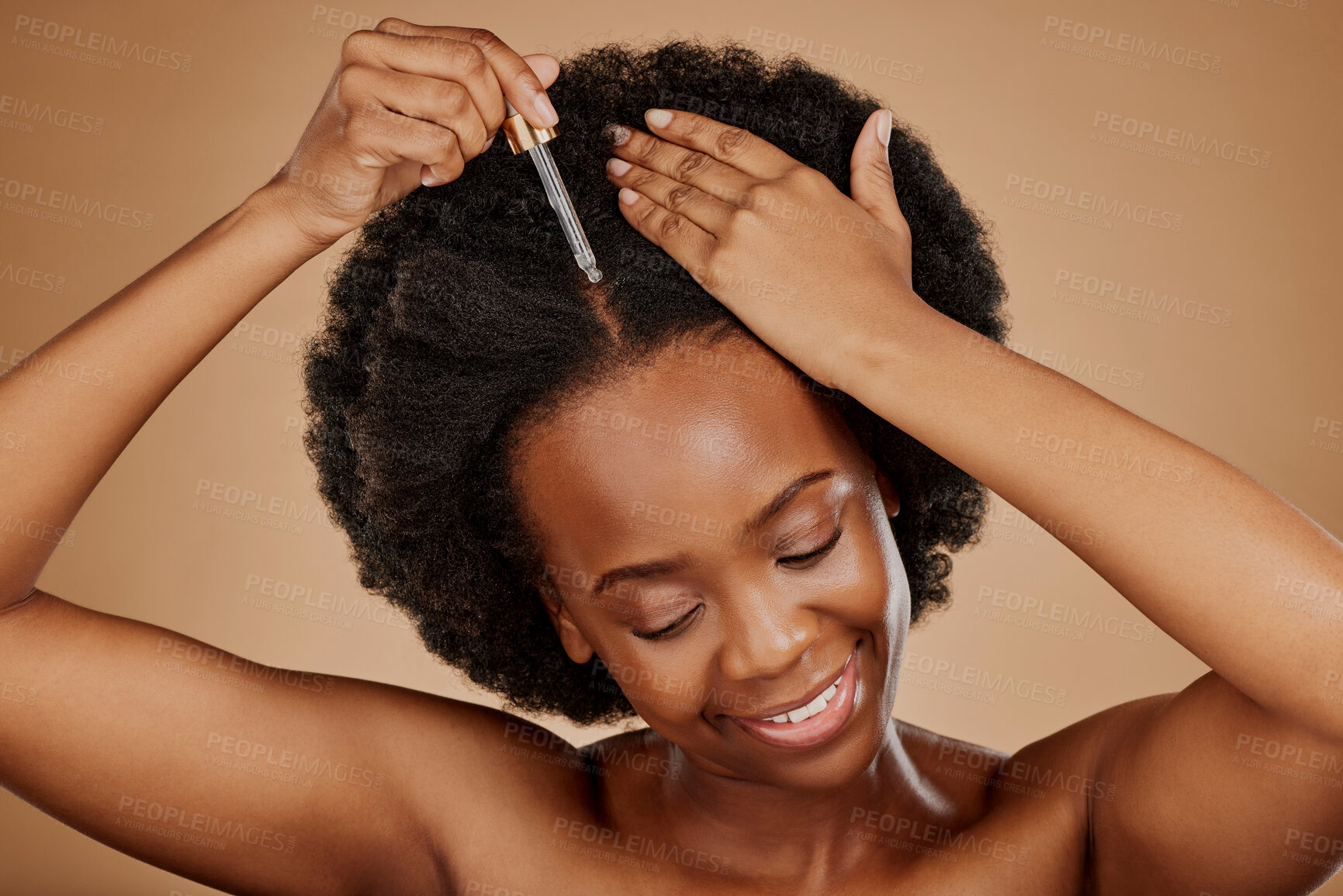 Buy stock photo Oil serum, hair care or black woman with afro in studio on brown background for a healthy scalp. Smile, pipette or natural African girl at hairdresser salon for hairstyle treatment or beauty makeover
