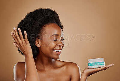 Buy stock photo Happy, thinking and a black woman with a product for hair care, wellness and shine. Smile, beauty and an African girl or model with a vision for afro cosmetics in a container on a studio background