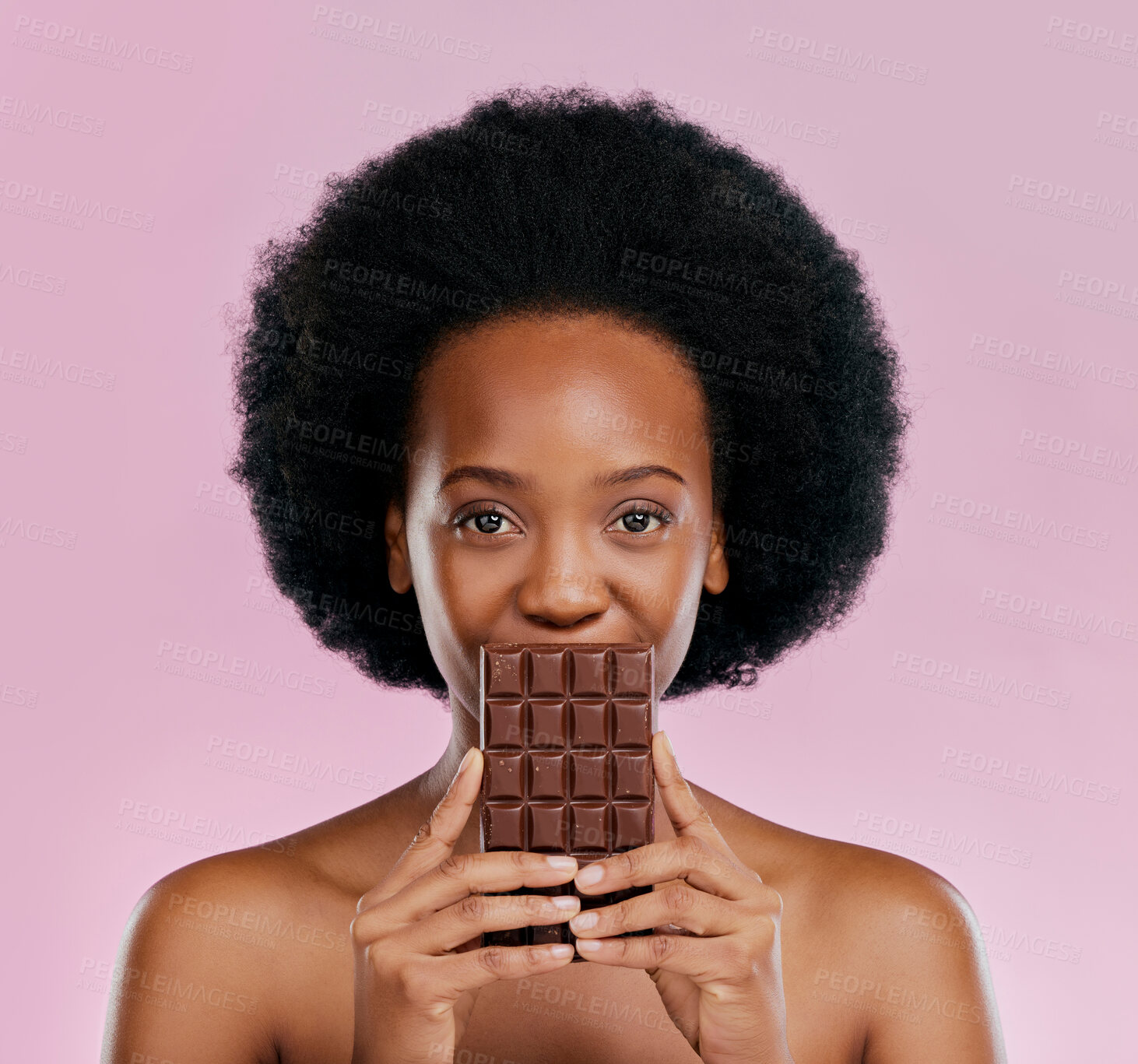 Buy stock photo Portrait, chocolate and black woman with snack, natural beauty and sugar treat on a studio background. Face, female person or Jamaican model with sweets, cocoa candy and delicious snack with calories
