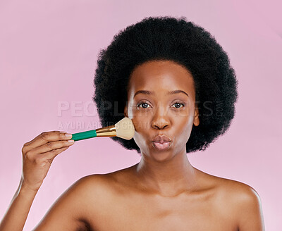 Buy stock photo Face, makeup and black woman with brush, kiss and beauty in studio isolated on a pink background. Portrait, facial cosmetics and African model apply foundation, powder and wellness for skincare pout.