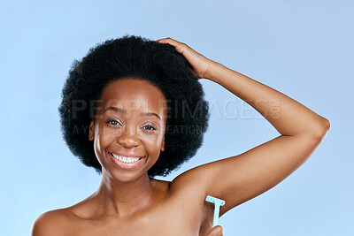 Buy stock photo Smile, portrait or black woman woman shaving armpit with a razor blade for hair removal, hygiene or wellness. Studio, blue background or happy girl model grooming underarms for healthy clean skincare