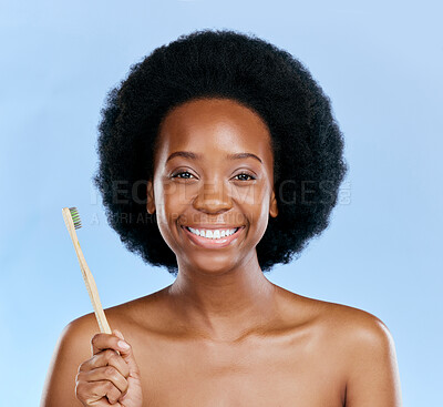 Buy stock photo Face, bamboo toothbrush and black woman smile in studio isolated on a blue background. Portrait, brushing teeth and model with natural, eco friendly or healthy wood for dental, cleaning or hygiene.