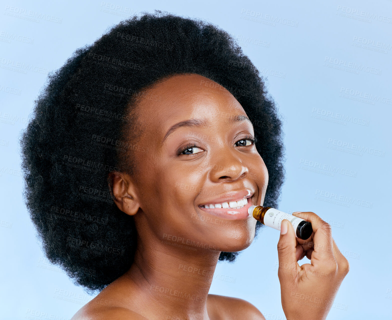 Buy stock photo Portrait, beauty and lip balm with a black woman in studio on a blue background for skincare cosmetics. Face, hydration and moisture with a happy young female model holding a makeup product for care