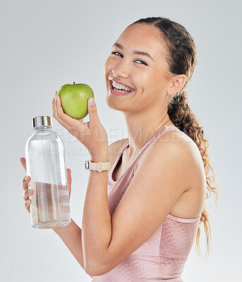 Buy stock photo Portrait, woman and water bottle with apple in studio for diet of healthy food, nutrition and detox for weightloss. Happy female fitness model, hydration and fruit to lose weight on white background