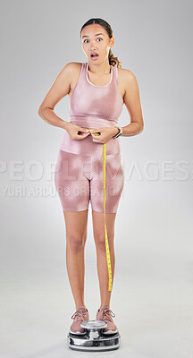 Buy stock photo Fitness, tape and surprise with woman on scale in studio for weight loss, achievement and workout. Health, goal and exercise with person measuring body on white background for diet, training or shock