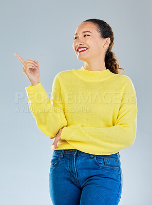 Buy stock photo Space, smile and presentation with woman and pointing in studio for show, advertising and idea. Announcement, promotion and deal with person on grey background for opportunity, offer and news mockup