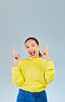 Pointing, happy and presentation with portrait of woman in studio for show, advertising and idea. Announcement, promotion and deal with person on grey background for opportunity, offer or news mockup