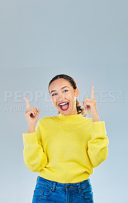 Buy stock photo Pointing, happy and presentation with portrait of woman in studio for show, advertising and idea. Announcement, promotion and deal with person on grey background for opportunity, offer or news mockup