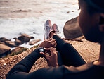 Relax, running  and smart watch with hand of woman on rock for check, fitness tracker and heart rate. Workout, exercise and goal with closeup of female runner at beach for monitor, goals and time