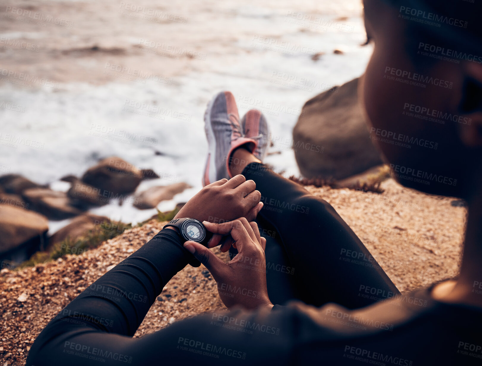 Buy stock photo Relax, running  and smart watch with hand of woman on rock for check, fitness tracker and heart rate. Workout, exercise and goal with closeup of female runner at beach for monitor, goals and time