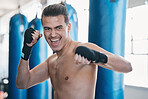 Sports, boxing and man in gym for training, workout and exercise for martial arts or mma fight. Fitness, body builder and face of excited male athlete ready for boxer competition, practice and punch