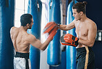 Sports, boxing and man with coach in gym for training, workout and exercise for mma. Fitness, body builder and male athlete with personal trainer for boxer competition, practice match and fighting