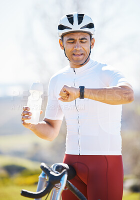 Buy stock photo Cycling, bike and man with a smart watch, fitness and exercise with workout goal, training, and water bottle. Male person, biker or athlete outside, checking time and monitor progress with online app