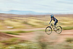 Fitness, adrenaline and man riding a bike in nature training for a race, marathon or competition. Sports, motion and male athlete biker practicing for an outdoor cardio exercise, adventure or workout