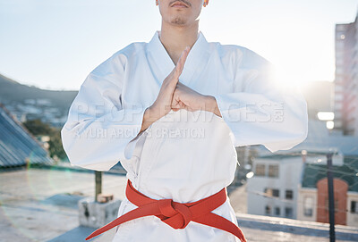 Buy stock photo Karate, exercise and discipline with a sports man in gi, training in the city on a blurred background. Fitness, respect or bow with a male athlete during a self defense workout for health closeup