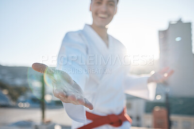Buy stock photo Karate, hand and fighting with a sports man in gi, training in the city on a blurred background. Exercise, gesture or virtue with a happy male athlete during a self defense workout for health closeup
