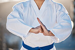 Sport, fitness and fighting with a karate man in gi, training in the city on a blurred background. Exercise, discipline or respect with a male athlete during a self defense workout for health closeup
