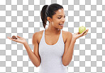 A gorgeous young woman in sportswear deciding whether to eat an apple or chocolate isolated on png background