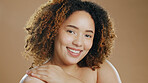 Face, black woman and skincare for shine, dermatology and healthy skin against a brown studio background. Portrait, African American female and lady with cosmetics, spa treatment and morning routine