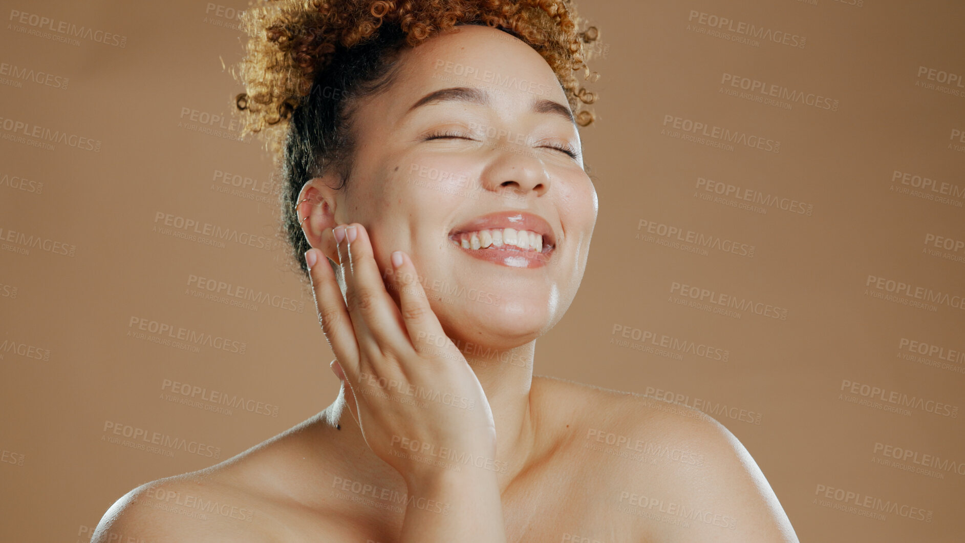 Buy stock photo Woman, eyes closed and touch face for skincare cosmetics in studio isolated on a brown background. Hand, natural beauty and happy model in spa facial treatment for glow, health and wellness of skin