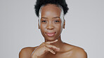 Black woman, face and smile in beauty portrait, facial and skincare glow isolated on studio background. Hand, touching skin and natural shine with dermatology, mockup space and cosmetic care wellness