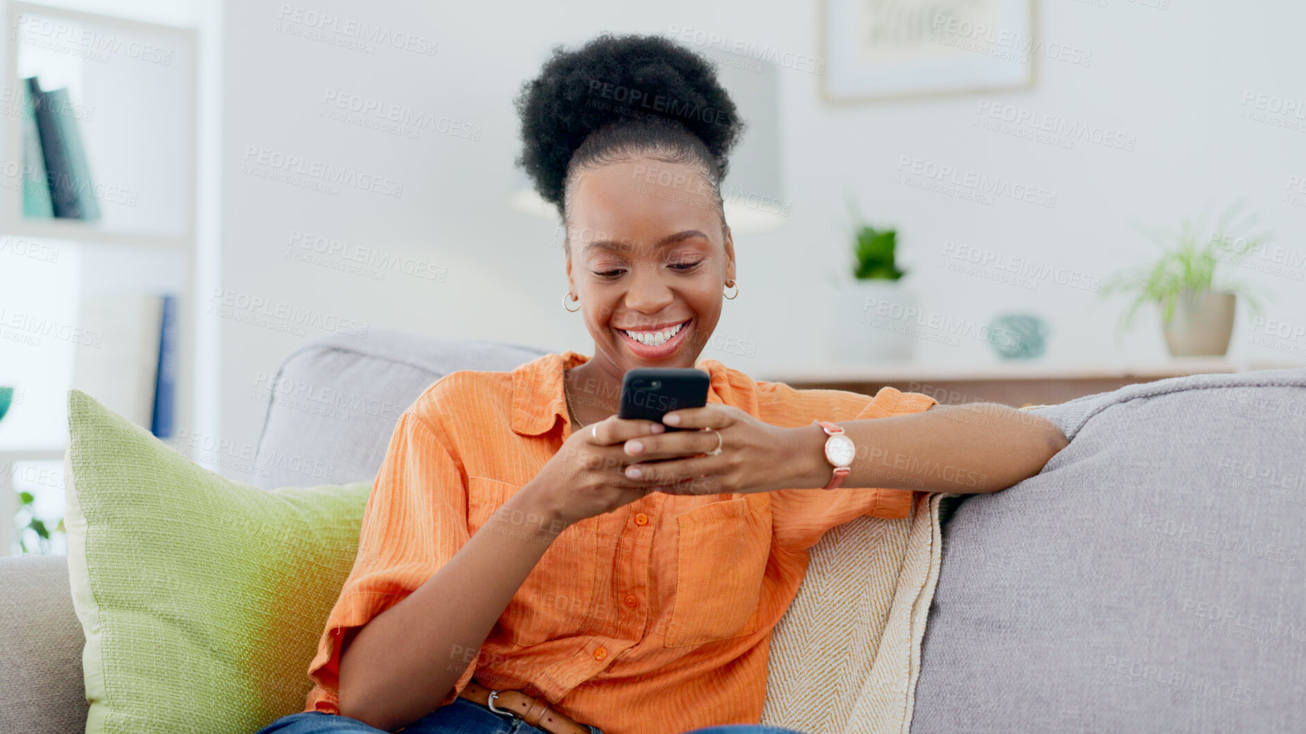 Buy stock photo Smile, black woman and typing on smartphone on sofa, update social media post and mobile chat at home. Cellphone, app and download digital games, reading multimedia connection and online subscription