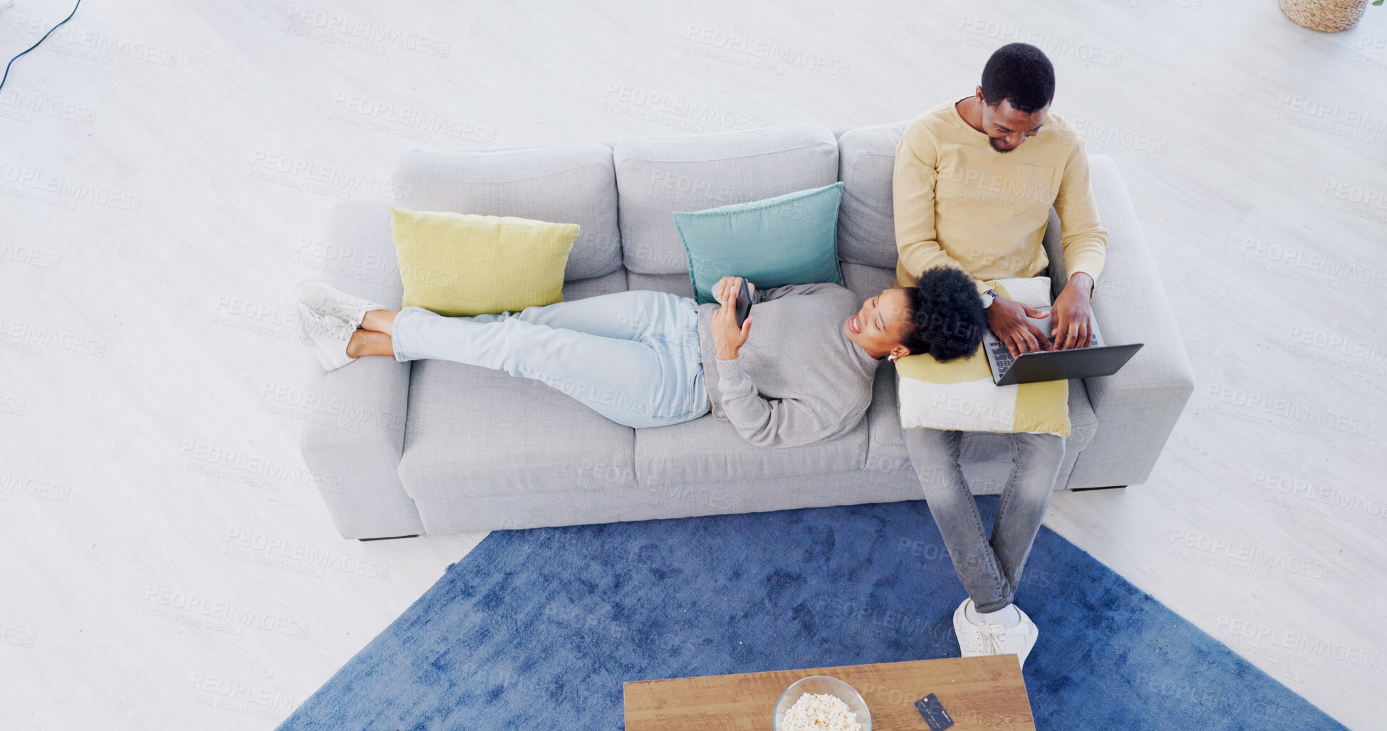 Buy stock photo Top view, home and couple with a cellphone, laptop and internet with connection, network and website information. Apartment, man and woman on a couch, cellphone and pc with online reading and relax