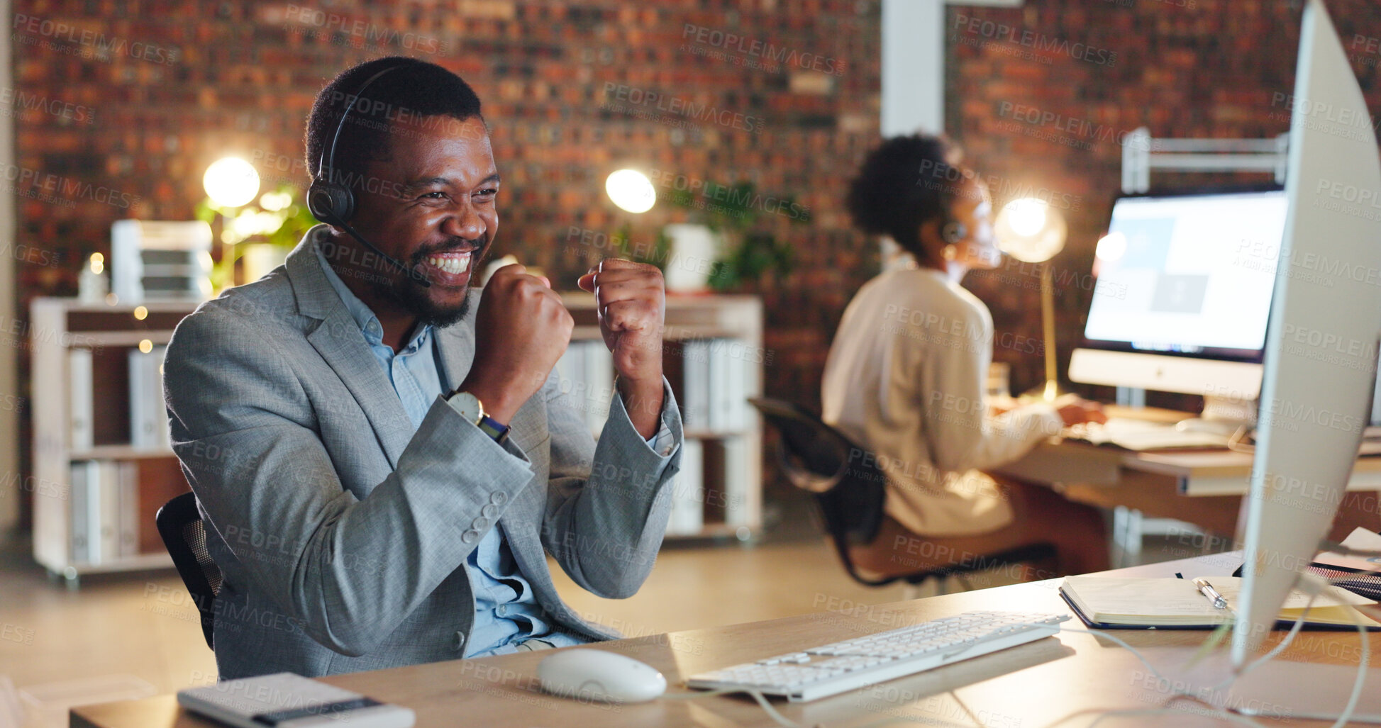 Buy stock photo African man, call center and celebration by computer, smile and excited for promotion, goals or success. Consultant, winner or agent in night, telemarketing or customer service with fist in workplace