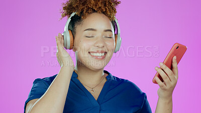 Buy stock photo Headphones, music and woman with smartphone in studio listening to song, audio or radio. Happy, smile and face of person with mobile app for streaming subscription, relax and fun on purple background