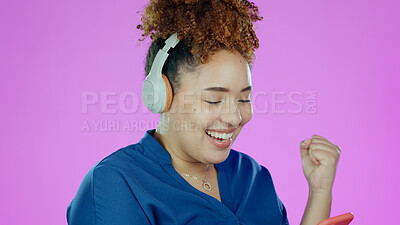 Buy stock photo Woman, phone and happy fist with headphones for winner, promotion or announcement in studio on purple background. Smartphone, person and excited for notification, sale and lottery with mock up space