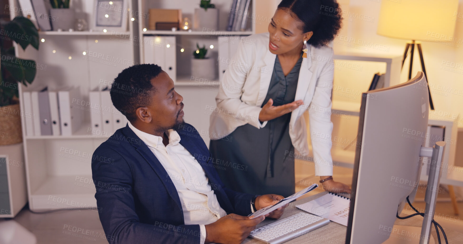 Buy stock photo Business people at night, team discussion for deadline and project report with corporate collaboration. Employees talking, black man and woman work overtime with paperwork, planning strategy at desk