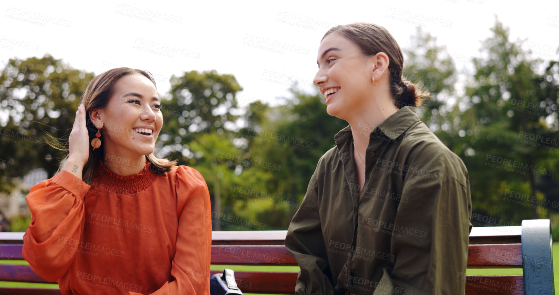 Buy stock photo Funny, friends and women at park bench, talking and communication outdoor. Conversation, relax and girls laughing in nature together, listening to story or gossip, happy and smile at comedy in garden