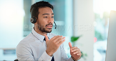 Call center agent consulting a buyer via video call in an office. A young friendly sales man talking to a client in a virtual meeting. A male customer service employee advising a consumer