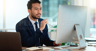 Buy stock photo Business man analyzing a project strategy on a computer screen while working in an office. Serious and focused corporate professional thinking of solutions while considering ideas, choices and plans