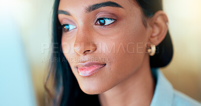 Buy stock photo Business woman reading information on a computer screen while working in an office. Closeup on face of one confident young entrepreneur and focused expert carefully analyzing ideas and plans online