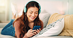 Girl, phone and music on sofa to relax with headphones with smile, typing and happy on social media. Woman, smartphone and streaming song on internet while reading communication, blog post or email