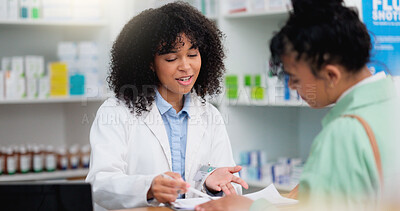 Pharmacist helping a customer in a pharmacy. Woman signing medical paperwork to collect over the counter and prescription medication from a friendly healthcare worker in a chemist or dispensary