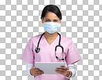 PNG cropped portrait of an attractive young female healthcare worker wearing a mask and stethoscope while using her tablet in studio against a grey background