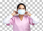 PNG cropped shot of an attractive young female healthcare worker wearing a mask and looking thoughtful in studio against a grey background