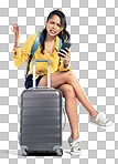 PNG Shot of a young woman using her cellphone while sitting on her suitcase