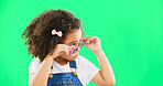 Green screen, fashion and child looking with sunglasses for trendy, stylish clothes and accessories. Emoji face, happy and portrait of girl with funny, comic and humour facial expression in studio