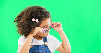 Green screen, fashion and child looking with sunglasses for trendy, stylish clothes and accessories. Emoji face, happy and portrait of girl with funny, comic and humour facial expression in studio