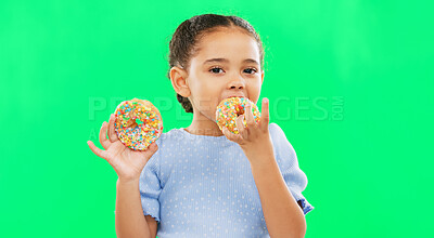 Candy, smile and child eating donuts on green background with cake for party, birthday and luxury. Food, excited kid and isolated happy girl with sweets, dessert treats and sugar doughnuts in studio