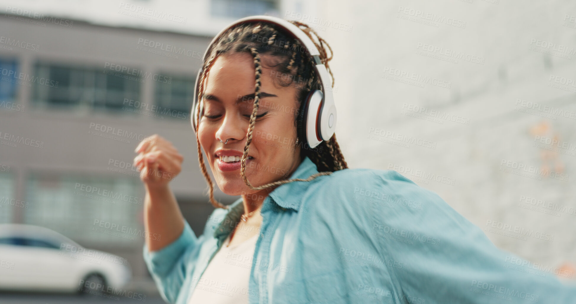 Buy stock photo Woman, dancing in city with headphones and music, fun and entertainment with hip hop and rhythm. Freedom, energy and audio streaming, playlist or radio with subscription and techno sound outdoor